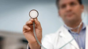 Doctor holding a stethoscope, representing accessible and ongoing medical care
