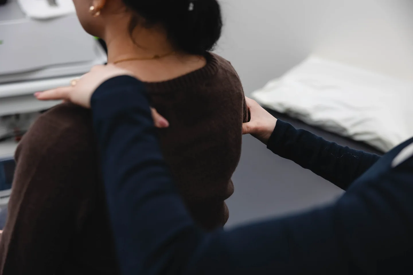 Athletic therapist assessing shoulder and upper back alignment