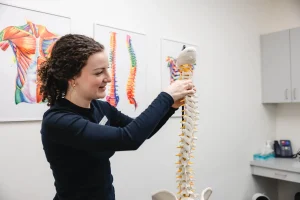 Athletic therapist demonstrating spinal alignment