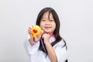 Child holding toy stethoscope, representing children’s health