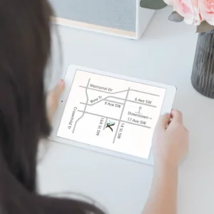 Person holding tablet showing map to Preventous clinic location in Calgary