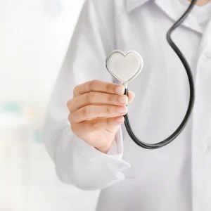 Doctor holding heart shaped stethoscope