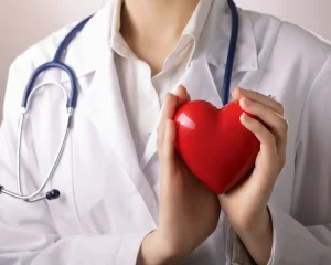 Doctor holding a red heart symbolizing care and compassion