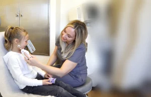 Healthcare provider examining a child in a clinic setting