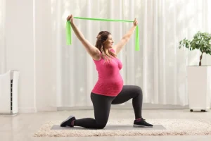 Pregnant woman exercising with resistance band