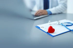 Stethoscope and heart on clipboard in medical office