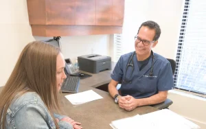 Dr. Rohan consulting with patient